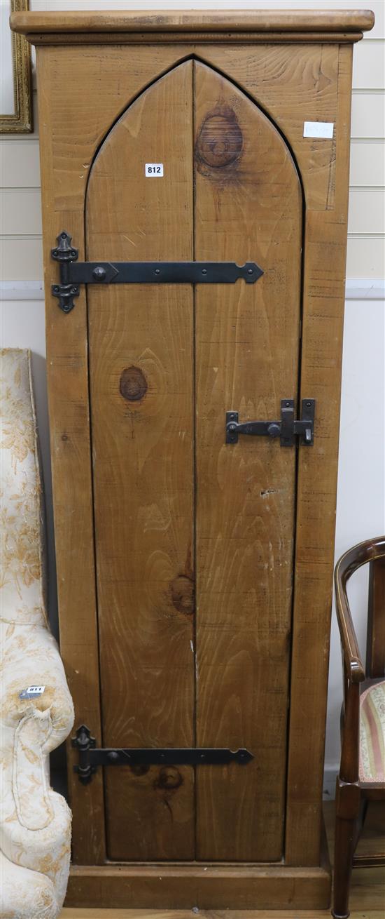 A narrow tall pine cupboard W.61cm